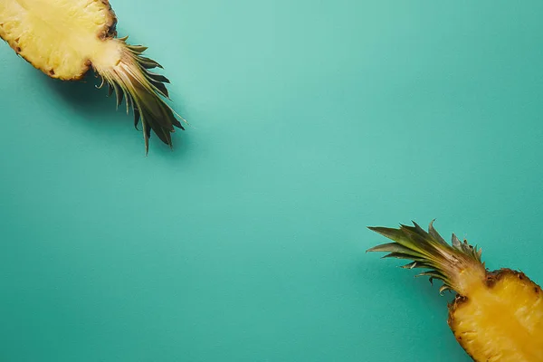 Top view of cut pineapple on turquoise surface — Stock Photo