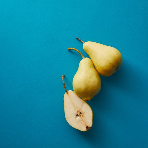 Top view of appetizing pears on blue surface — Stock Photo