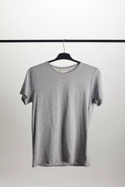 One grey shirt on hanger isolated on white — Stock Photo