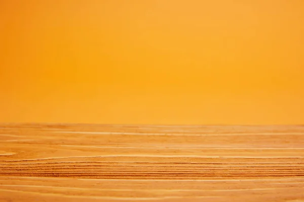 Empty wooden surface and bright orange background — Stock Photo