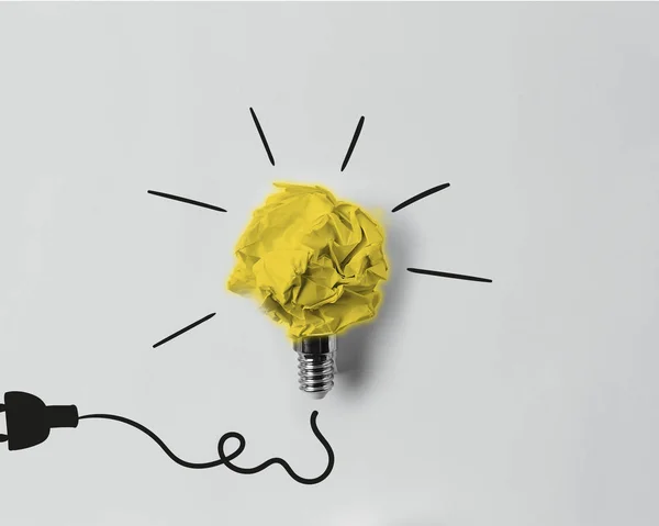 Top view of crumpled paper as light bulb with drawn plug — Stock Photo