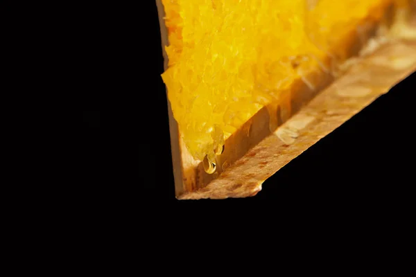 Close up view of beeswax isolated on black — Stock Photo