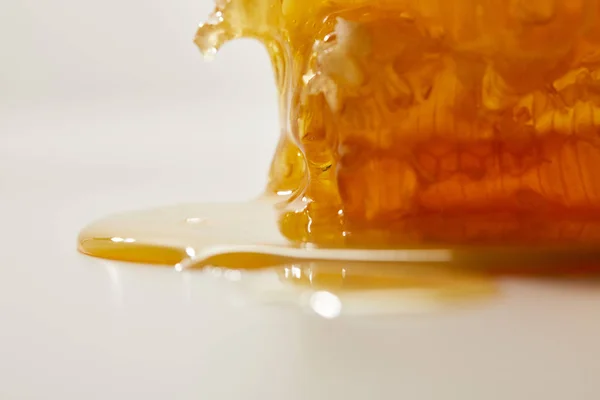 Close up view of sweet beeswax and honey on white background — Stock Photo
