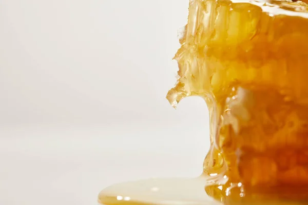 Close up view of sweet beeswax and honey on white background — Stock Photo