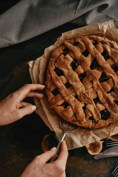 Partial view of woman with cake server taking piece of pie — Stock Photo