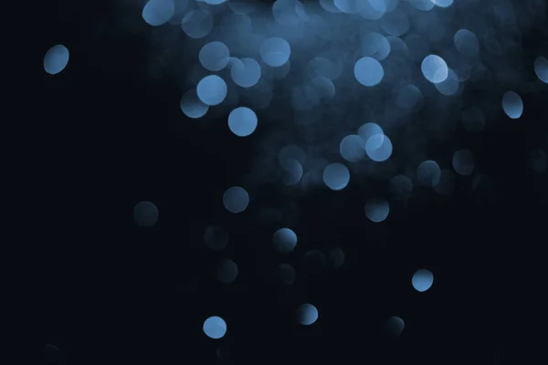 Blue decorative bokeh on black background — Stock Photo