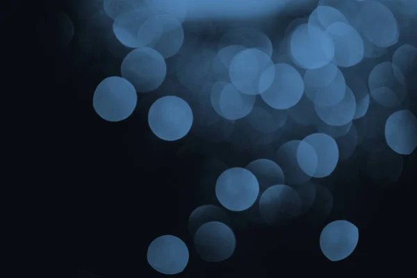 Blue bokeh on black festive background — Stock Photo