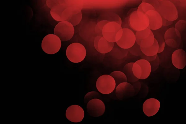 Bokeh rosso su sfondo nero festivo — Foto stock