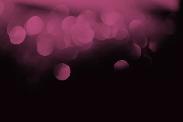 Purple festive bokeh on black background with copy space — Stock Photo