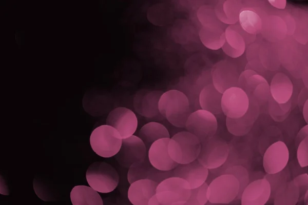 Purple bokeh on black background for holiday — Stock Photo