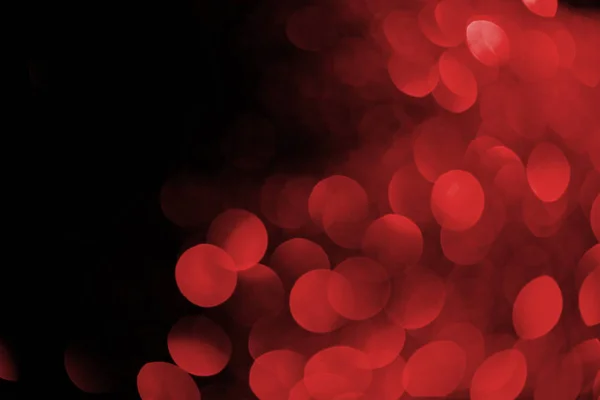 Red bokeh on black background for holiday — Stock Photo