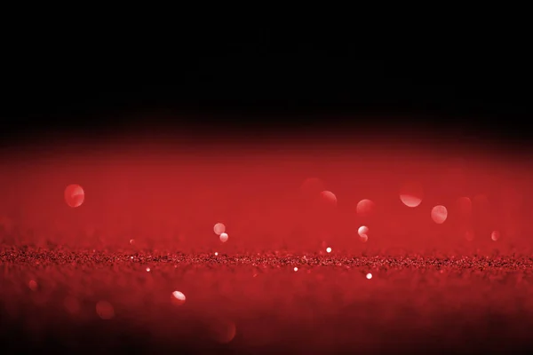 Étincelle paillettes rouges avec bokeh sur fond noir — Photo de stock