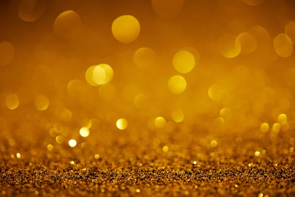 Abstract golden glitter with bokeh on background — Stock Photo