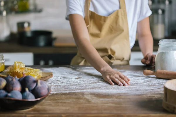 Cropped shot of woman covering table with flour for dough preparation — Stock Photo
