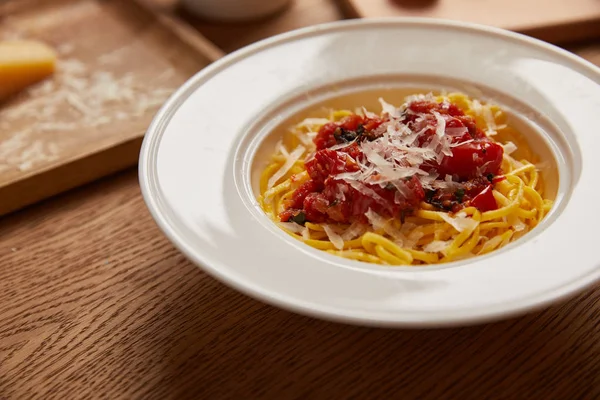 Plate of delicious pasta on wooden table — Stock Photo