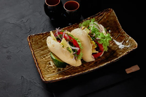 High angle view of delicious fresh buns with vegetables on plate — Stock Photo