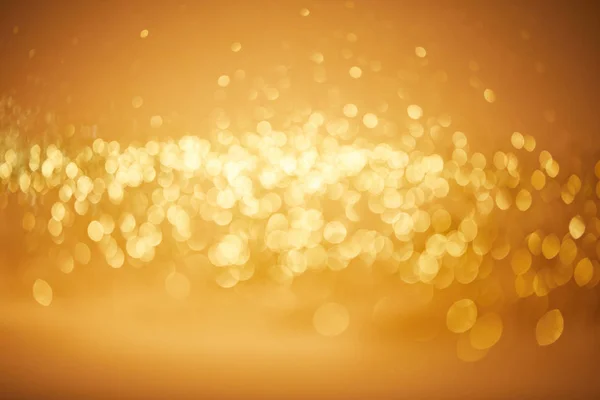 Blurred golden bokeh christmas background — Stock Photo