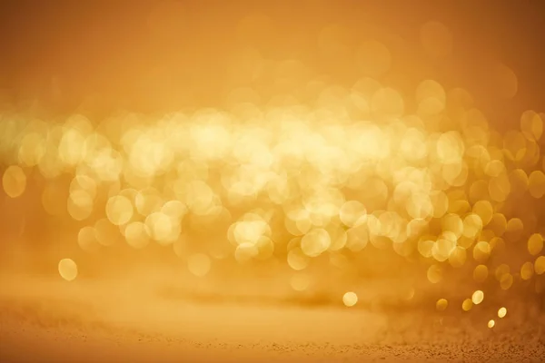 Golden bokeh christmas background with glossing sequins — Stock Photo