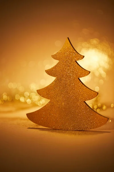 Golden glittering christmas tree for decoration on tabletop — Stock Photo