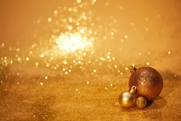 Golden glittering christmas toys for decoration on tabletop — Stock Photo