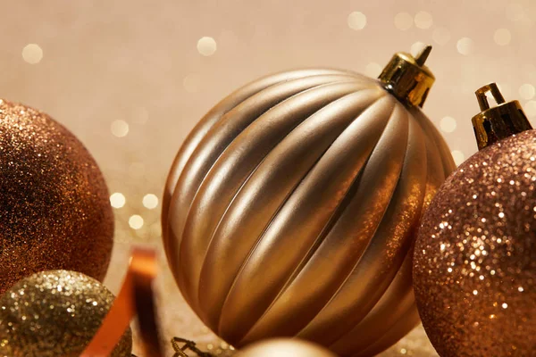 Close up of glittering bright christmas balls on beige background — Stock Photo