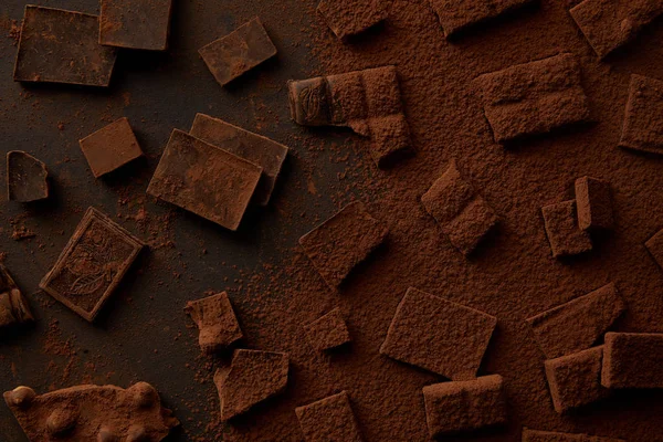 Top view of gourmet chocolate pieces and cocoa powder — Stock Photo