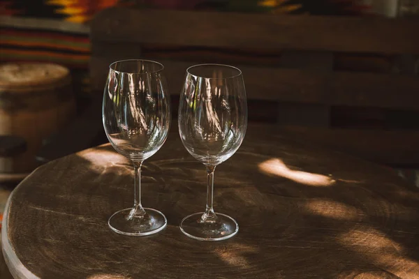 Close-up shot of glasses for wine on rustic wooden table — Stock Photo
