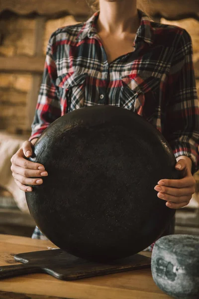 Cropped shot of woman holding big cheese head — Stock Photo