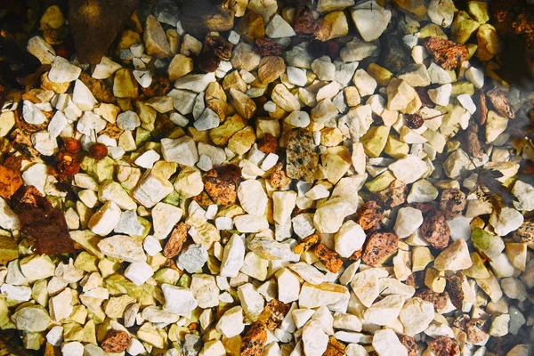 Top view of textured yellow and white pebble stones ground — Stock Photo