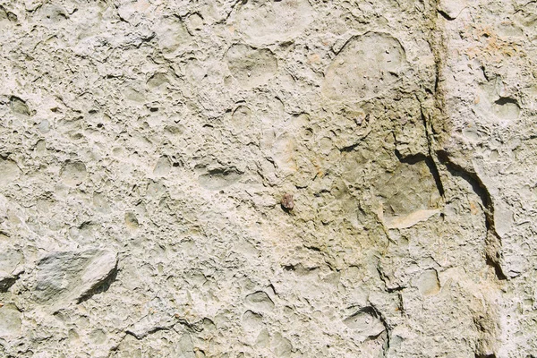 Elevated view of light uneven textured stone — Stock Photo