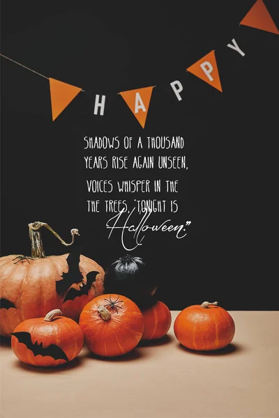 Pumpkins, paper bats and paper garland with word happy and halloween poem — Stock Photo