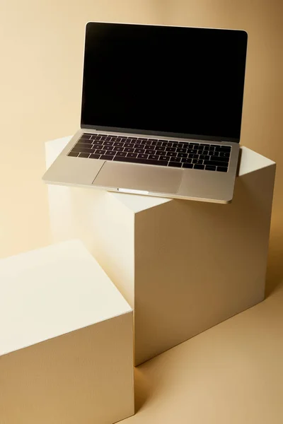 Close-up shot of laptop with blank screen on beige cubes — Stock Photo