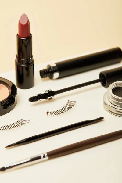 Close-up shot of makeup accessories kit on beige — Stock Photo