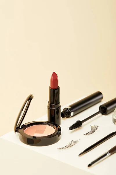 Close-up shot of makeup supplies kit on beige — Stock Photo