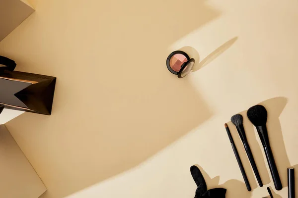 Top view of makeup supplies lying on beige tabletop — Stock Photo