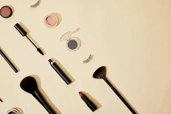 Flat lay with composition of different cosmetics lying on beige tabletop — Stock Photo