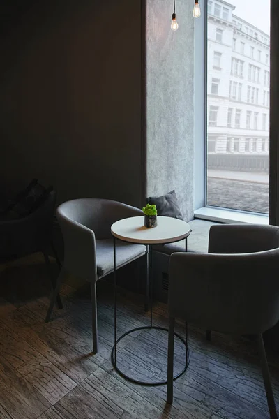 Modern cafe interior with comfortable furniture near window — Stock Photo