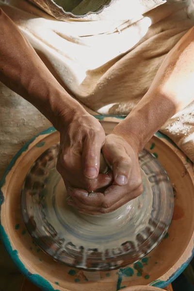 Partial view of professional potter working on pottery wheel at workshop — Stock Photo