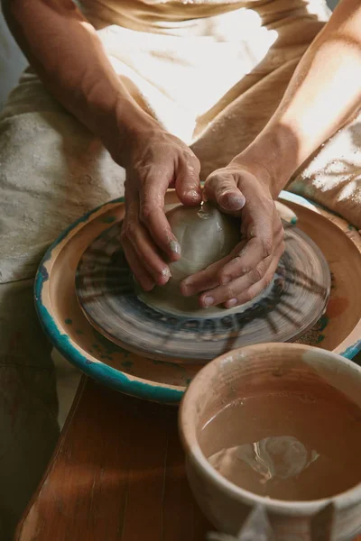 Partial view of professional potter working with clay at workshop — Stock Photo