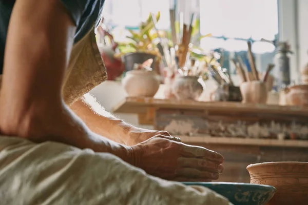 Selective focus of professional potter working with clay at potter studio — Stock Photo