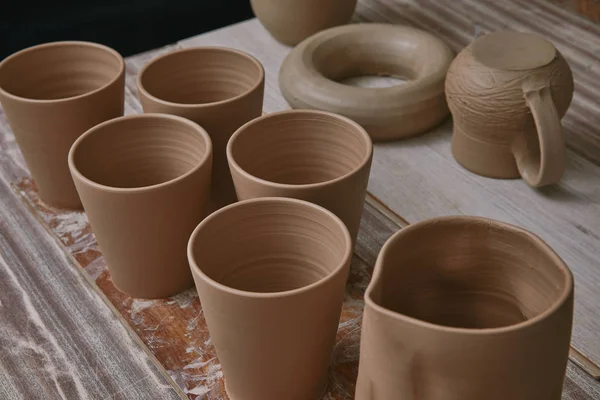 Selective focus of ceramic pots at table in pottery studio — Stock Photo