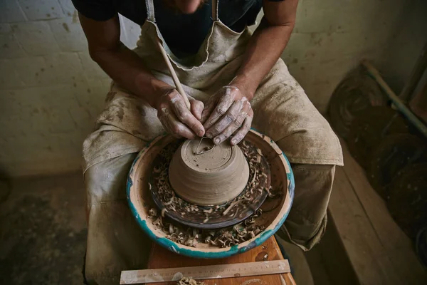 Imagem cortada de oleiro profissional decorando pote de barro na oficina — Fotografia de Stock