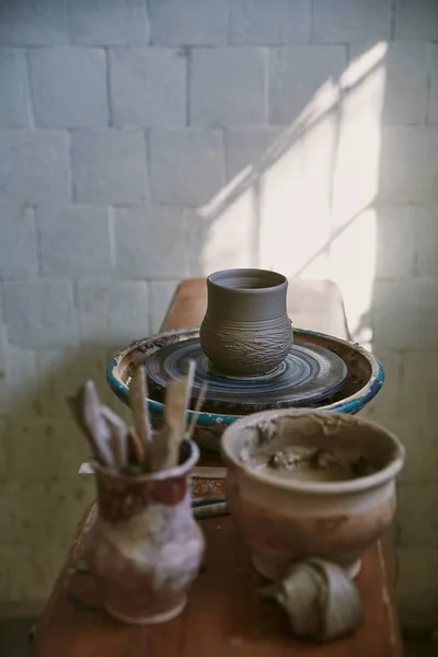 Selective focus of clay pot on pottery wheel at workshop — Stock Photo