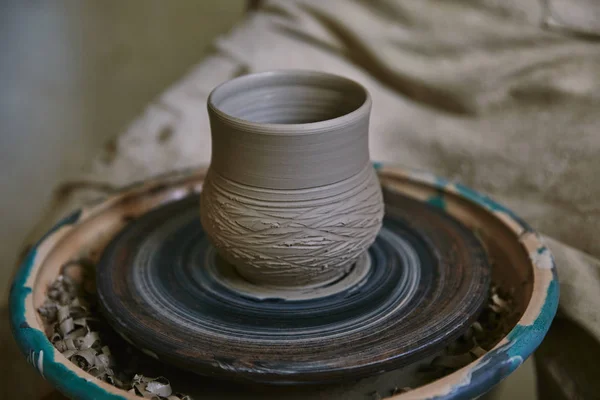 Selective focus of clay pot on pottery wheel at workshop — Stock Photo