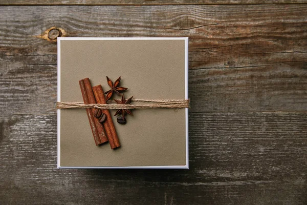 Top view of box decorated with spices on rustic wooden table — Stock Photo