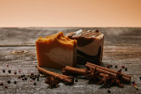 Close-up shot of soap pieces with spices on rustic wooden tabletop — Stock Photo