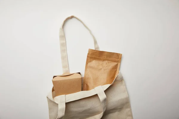 Top view of cotton bag with cardboard noodle box on white surface — Stock Photo