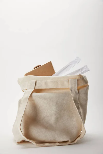 Vista de cerca de la bolsa de algodón con palillos y caja de fideos en blanco - foto de stock