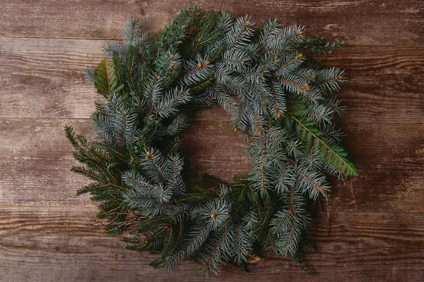 Top view of Christmas fir wreath on wooden table — Stock Photo
