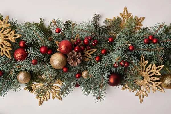 Top view of fir twigs with colored Christmas decoration isolated on white — Stock Photo